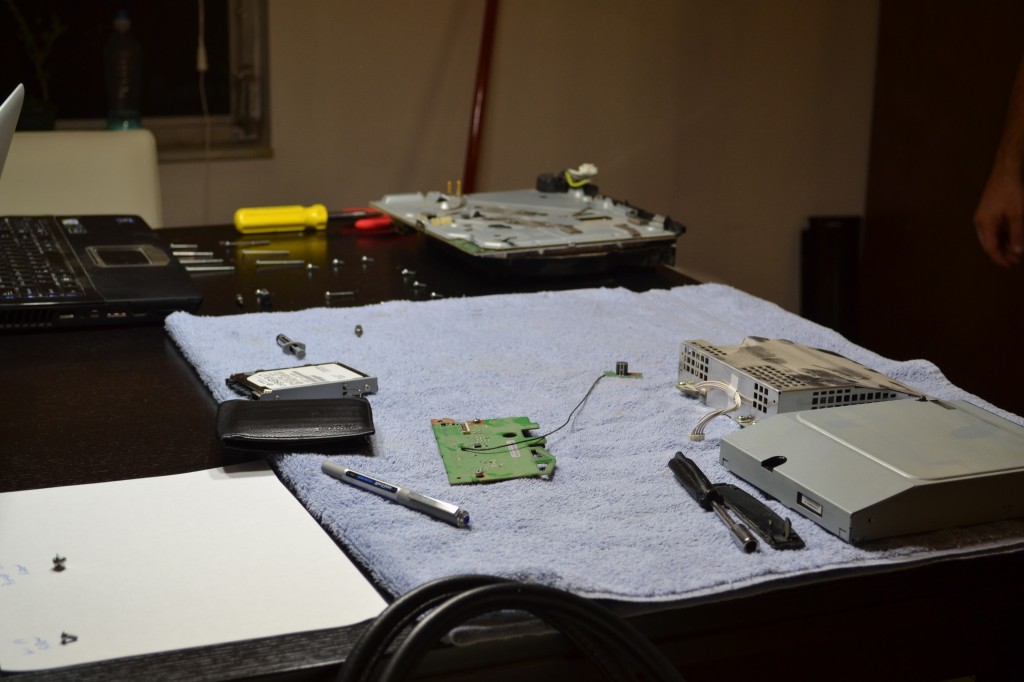 In surgery: guts on the table.  Power supply, blue-ray player, small circuit board.